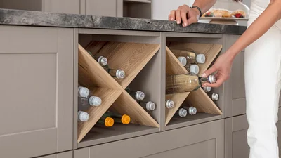 Storage space with style: open shelf with wine cross for bottles.