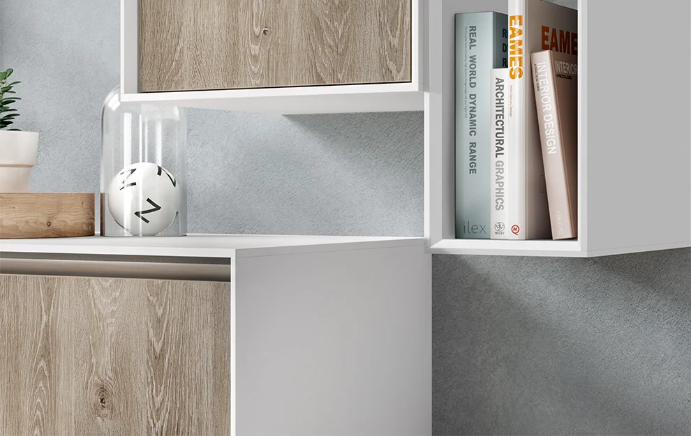 Nowoczesna minimalistyczna półka z książkami o architekturze i designie, ozdobna roślina i zegar, na tle szarej ściany o teksturze.
